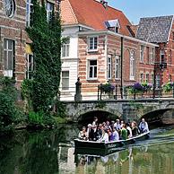 Tourists in boat under bridge over the river Little Nete, Lier, Belgium